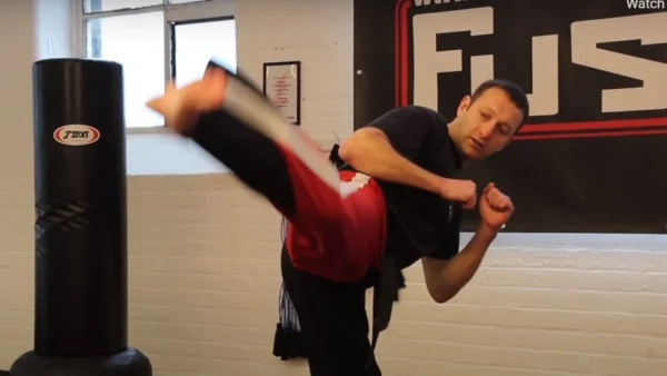 Black Belt Kickboxer demonstrating a high round kick.