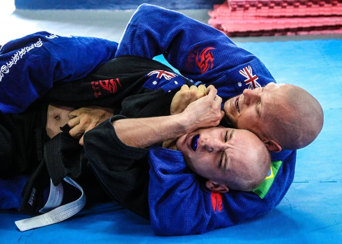 Martial Artists grappling in Jiu Jitsu bout.